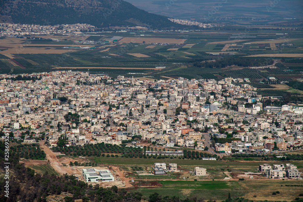 Mount Tabor in the Lower Galilee region of Northern Israel rises with its distinctive shape from the flat and fertile Jezreel Valley. Mount Tabor is important as a Biblical site