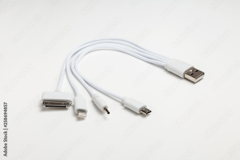 white universal charging cable, adapter with micro USB, usb connectors for different models of phones and devices on a white background white universal charging cable, adapter with micro USB, usb connectors for different models of phones and devices on a white background