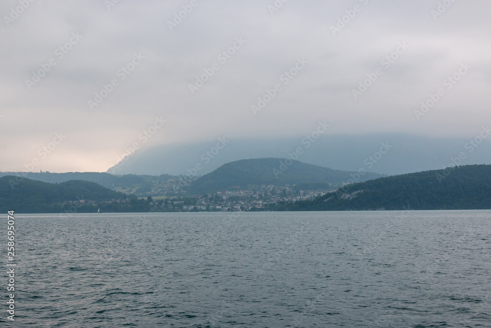 View on lake Thun and mountains from ship in city Spiez, Switzerland