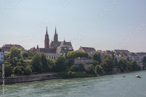 View on Basel city and river Rhine, Switzerland. People swim in water © TravelFlow