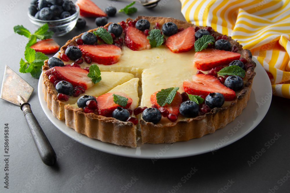 Cheesecake with fresh berries and mint for dessert - healthy organic summer dessert pie cheesecake. Cheese cake. Gray background. Cheesecake with fresh berries and mint for dessert - healthy organic summer dessert pie cheesecake. Cheese cake. Gray background.