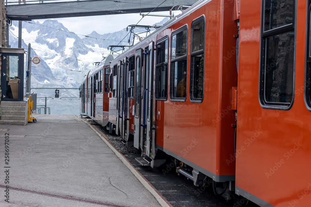 orange train high in Alps Switzerland mountains
