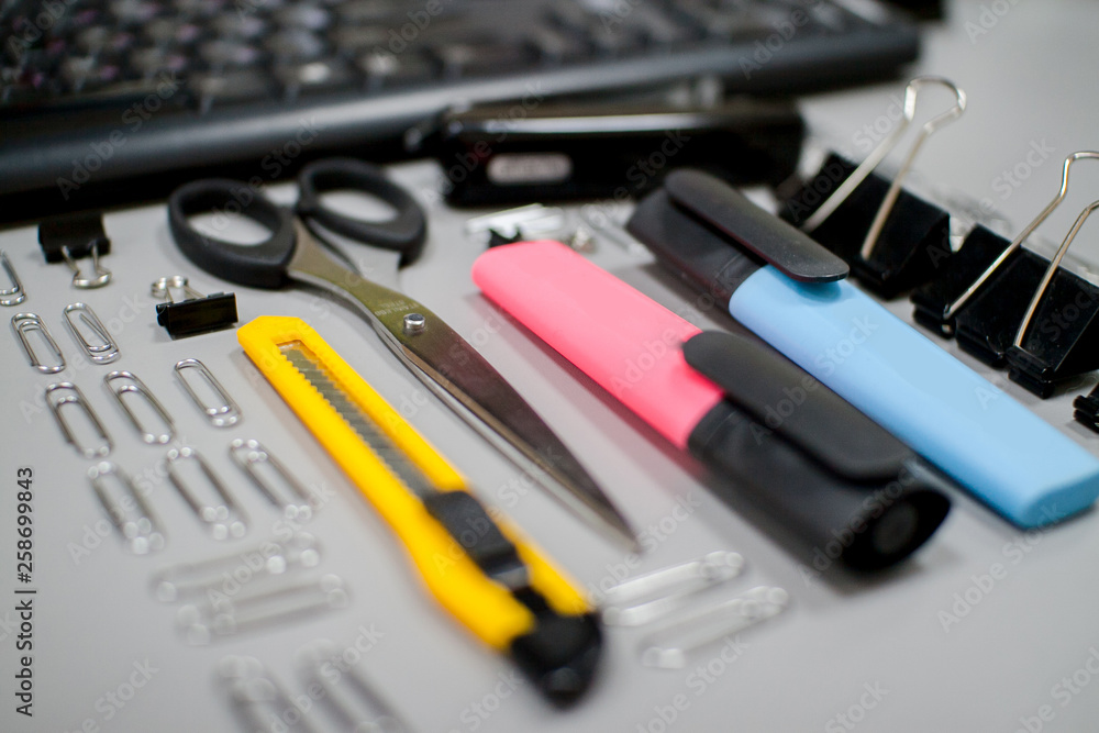 Office workplace, stationery, calculator, keyboard, phone on gray background Office workplace, stationery, calculator, keyboard, phone on gray background