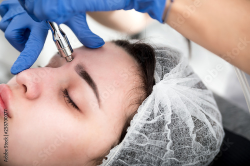 Professional skin care, procedure Microdermabrasion of the facial skin at cosmetic clinic photo