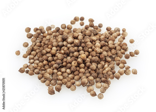 Heap of dried coriander seeds isolated on white background