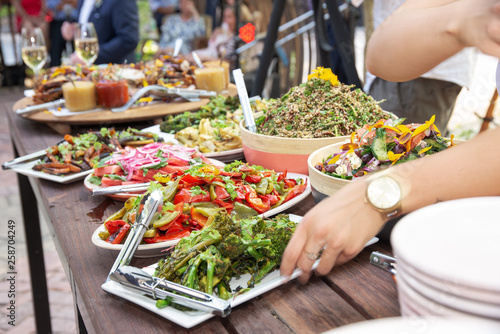 Serving food at a large outdoor, alfresco bbq photo
