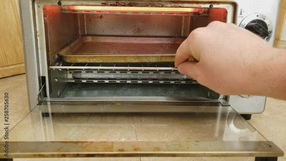 Home cooking Opening and sliding out baking tray from counter top