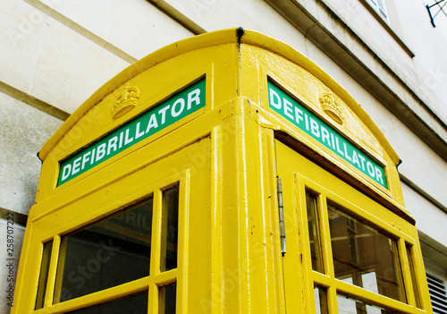 Iconic British red phone booth repurposed as defibrillator station and painted yellow