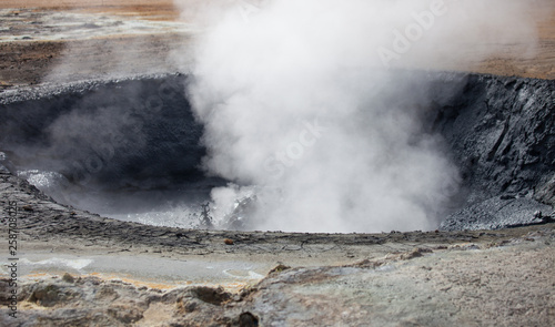 Iceland geothermal zone Namafjall - area in field of Hverir. Closeup photo of pools with boiling mud. Tourist and natural attractions.