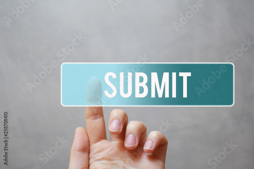 Submit - finger pressing blue transparent button on virtual touchscreen interface on gray background with copy space for text.