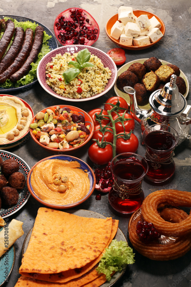 Middle eastern or arabic dishes and assorted meze, concrete rustic background. Falafel. Turkish Dessert Baklava with pistachio. Halal food. Lebanese cuisine Middle eastern or arabic dishes and assorted meze, concrete rustic background. Falafel. Turkish Dessert Baklava with pistachio. Halal food. Lebanese cuisine