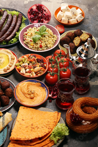Middle eastern or arabic dishes and assorted meze, concrete rustic background. Falafel. Turkish Dessert Baklava with pistachio. Halal food. Lebanese cuisine