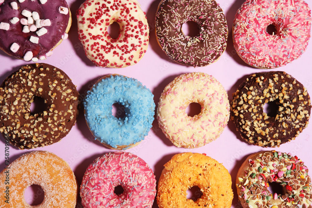 assorted donuts with chocolate frosted, pink glazed and sprinkles donuts. assorted donuts with chocolate frosted, pink glazed and sprinkles donuts.