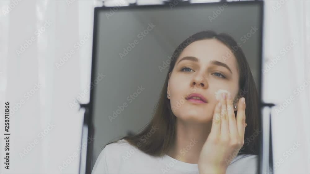 Portrait of a woman with cosmetic mask on her face. Portrait of a woman with cosmetic mask on her face.
