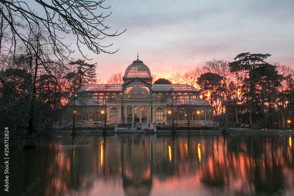 The Palacio de Cristal at sunset (Crystal Palace) is a glass and metal structure located in Madrid's Buen Retiro Park