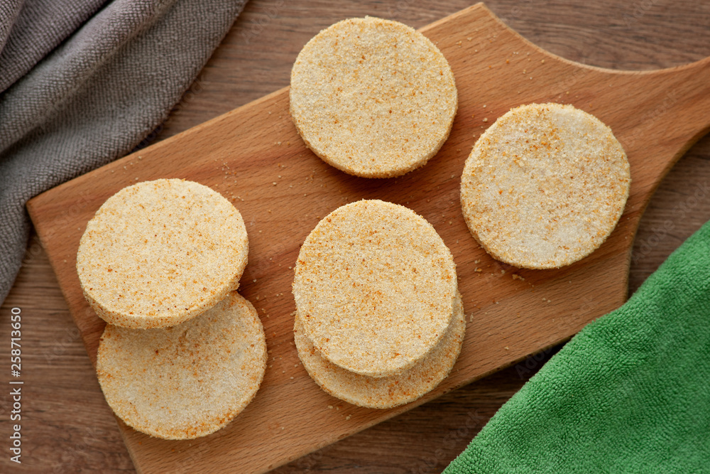 Semi-finished products as cutlets. Raw minced fish cutlets on a cutting board. Semi-finished meatballs for cooking. Breaded fishcakes. Semi-finished products as cutlets. Raw minced fish cutlets on a cutting board. Semi-finished meatballs for cooking. Breaded fishcakes.