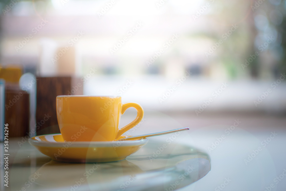 A coffee cup on the breakfast table with country view in the cafe A coffee cup on the breakfast table with country view in the cafe