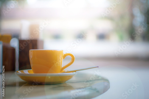 A coffee cup on the breakfast table with country view in the cafe