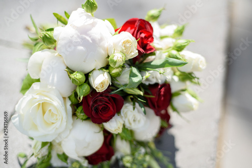 Wedding bouquet in hands and bride s dress