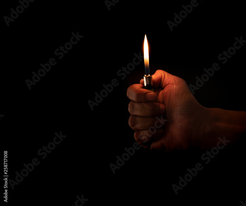 hand holding burning lighter photo