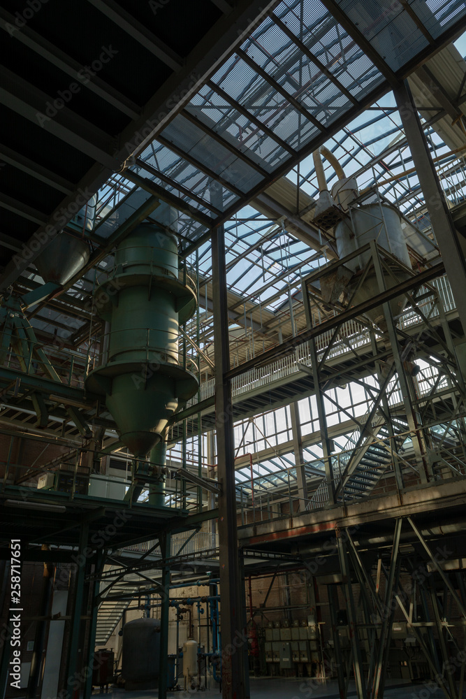 Industrial background, old abandoned factory hall with stairs and day light