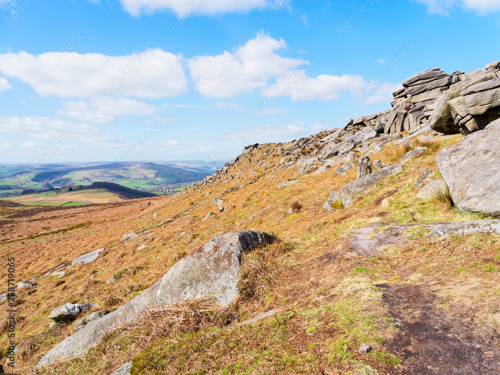 Down the Higger Tor ridge line on a bright spring day in Derbyshire.