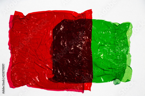 Billede på lærred Thin sheet of multi coloured cellophane with shiny crumpled surface texture on w