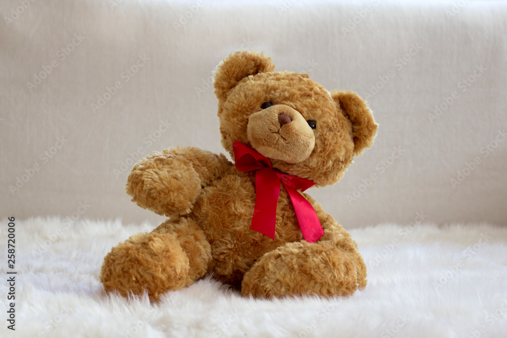 teddy bear with red bow on fur