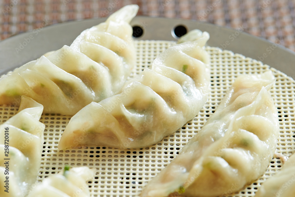 Pork and chives dumpling on steamer Pork and chives dumpling on steamer