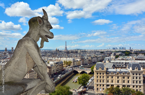 Notre Dame de Paris Cathedral. Famous Chimera (demon) overlooking the Eiffel Tower. Paris, France © MarinadeArt