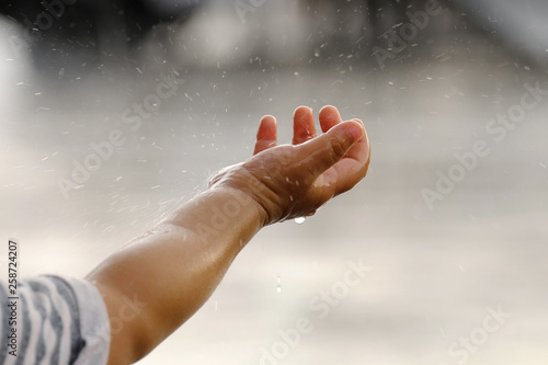 Raining into children's hands.