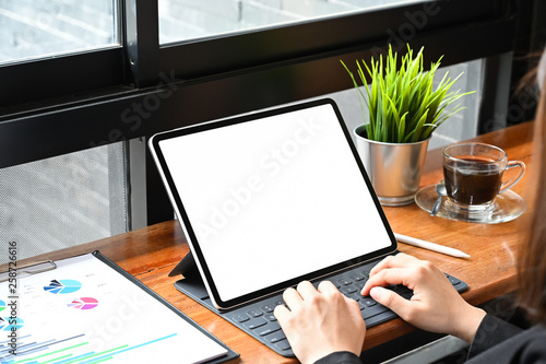 Business woman using mockup tablet with finance paper, Close up shot.