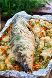 Baked mackerel with vegetables - potatoes, carrots, onions, green peas, top view