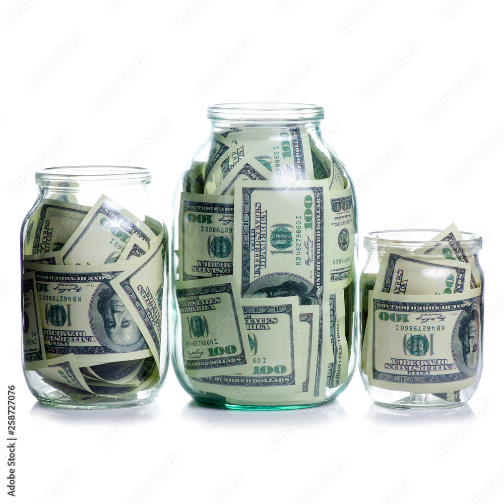 Money dollars bank notes in glass jar isolated on white background, concept save money Money dollars bank notes in glass jar isolated on white background, concept save money
