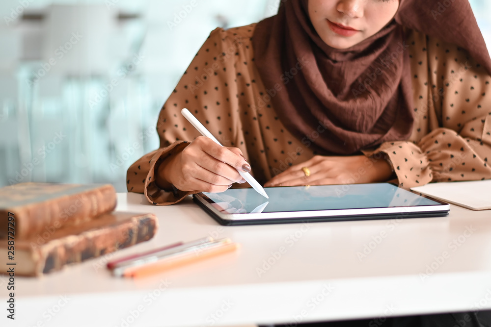 Islam woman working with digital tablet and pen on office workplace. Islam woman working with digital tablet and pen on office workplace.