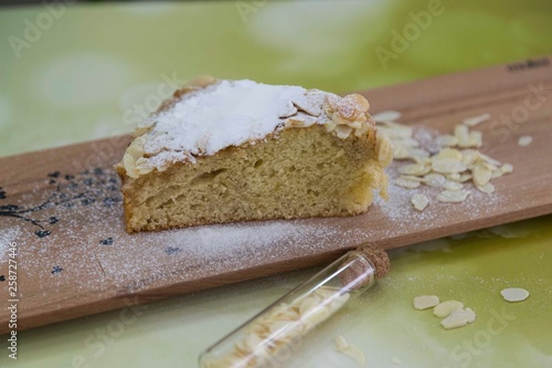 pieces of German butter cake with almonds on the wooden table