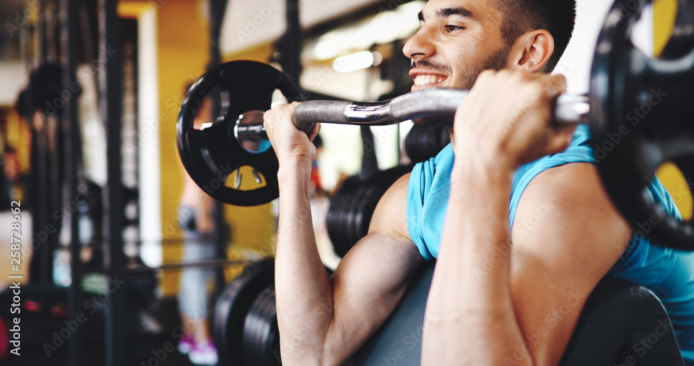 Muscular bodybuilder workout in gym doing biceps exercises Stock Photo ...