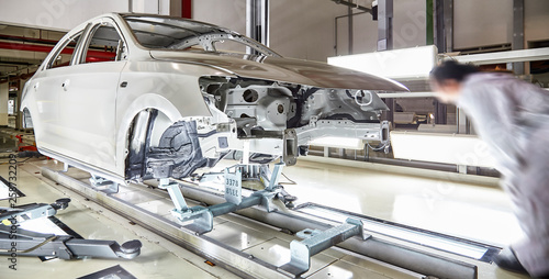 Automotive manufacturing inspectors are testing body structure