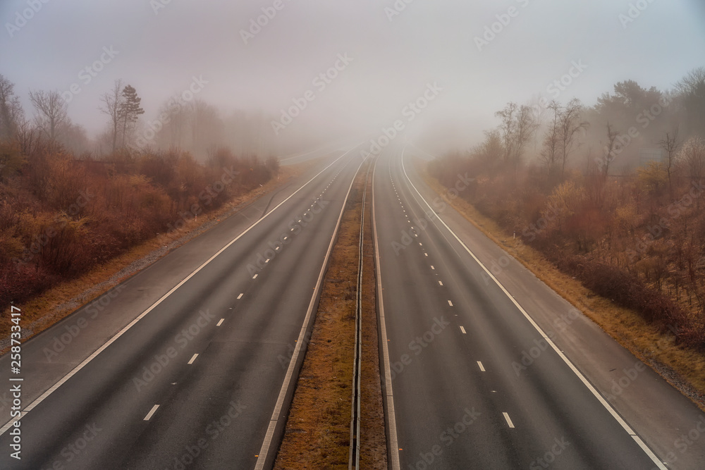 Early morning fog creating difficult driving conditions on the M4 motorway in Swansea, South Wales, UK