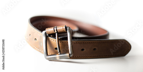 Close up of worn belt with white background