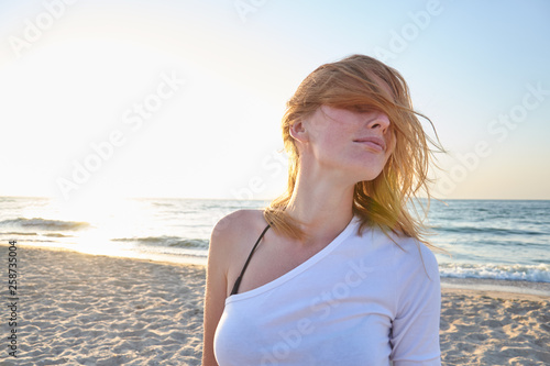 Portrait of handsome woman on sea background. Concept of holiday
