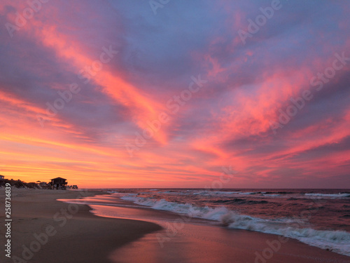 Amazing orange, pink, red, and purple sunset along the beach in the outer banks of North Carolina