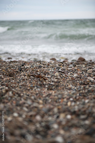 View of the baltic sea and stone beach, stormy sea waves 