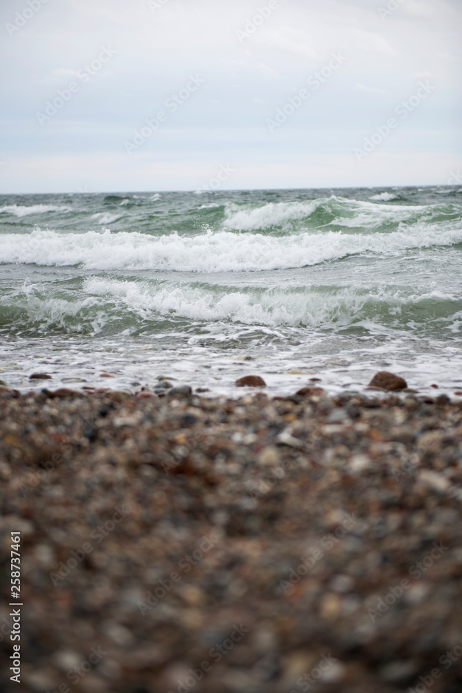 View of the baltic sea and stone beach, stormy sea waves View of the baltic sea and stone beach, stormy sea waves