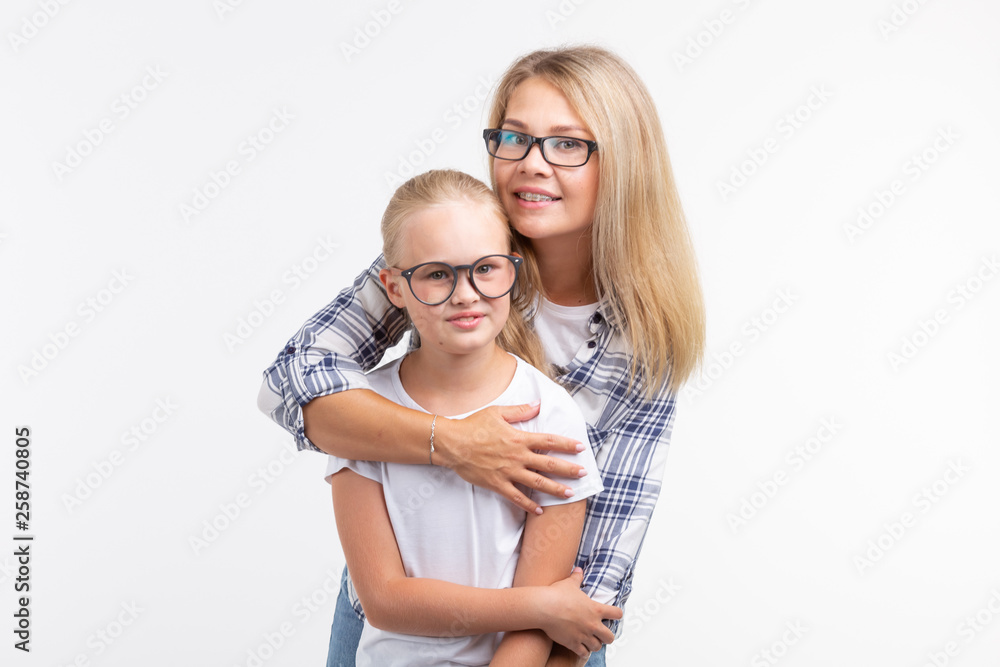 Portrait of mother and daughter with eyeglasses on white background Portrait of mother and daughter with eyeglasses on white background