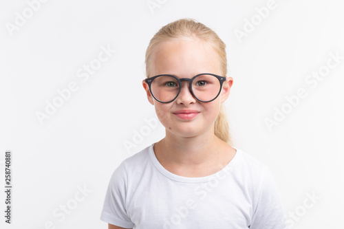 Fototapeta Naklejka Na Ścianę i Meble -  Beautiful child girl wearing glasses isolated on white