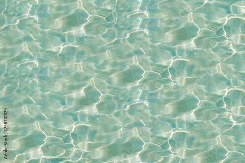 Blue ripped water with sunny reflections. Water in rippled water detail background