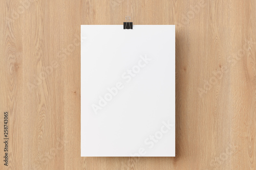 Blank paper poster hanging on binder clip