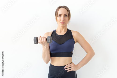 Healthy lifestyle, people and sport concept - Athletic woman doing exercise for arms