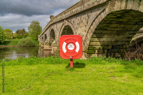 A lifebuoy at Atcham Old Bridge over the River Severn in Atcham, near Shrewsbury, Shropshire, England, UK photo